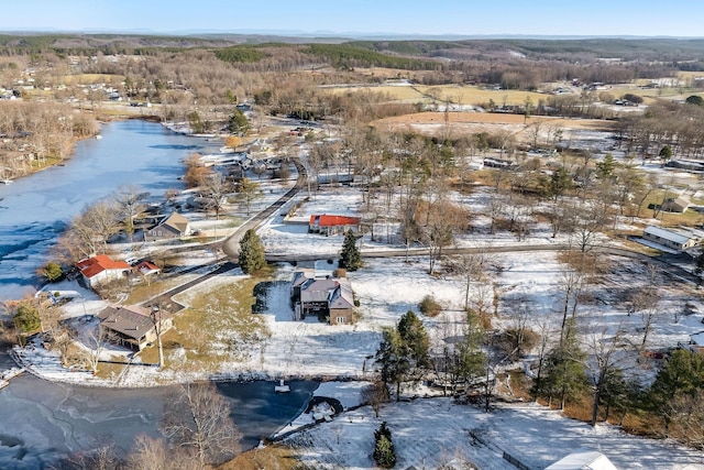 snowy aerial view featuring a water view