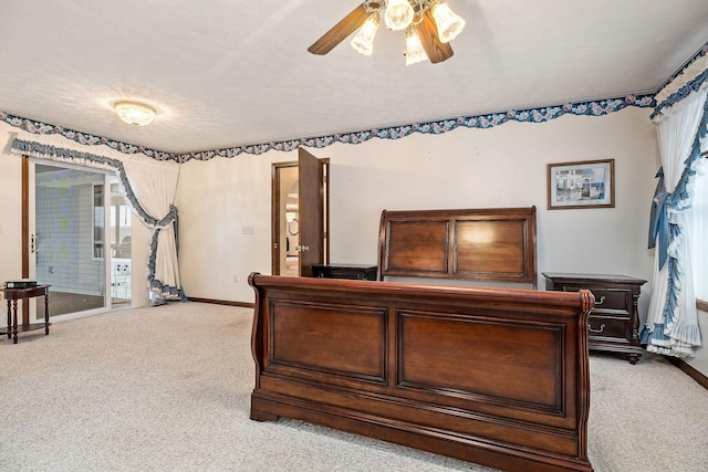 bedroom featuring ceiling fan, access to exterior, carpet, and a textured ceiling