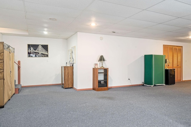 basement featuring carpet floors and a drop ceiling