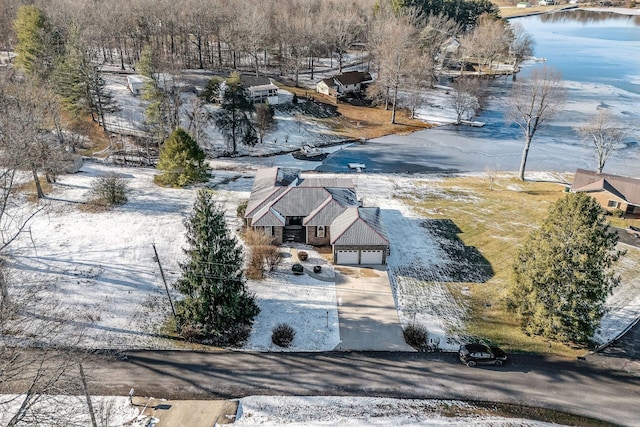 snowy aerial view with a water view