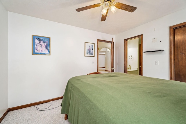 bedroom with ceiling fan, carpet floors, and ensuite bath