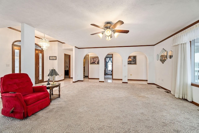 interior space featuring a textured ceiling, light colored carpet, and ceiling fan with notable chandelier