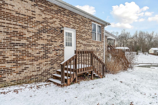 view of snow covered property entrance