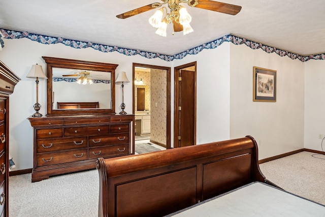 bedroom with ensuite bath, ceiling fan, and light carpet