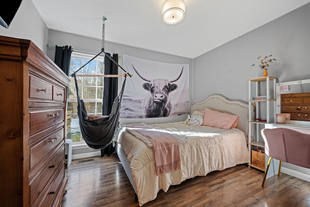 bedroom with dark hardwood / wood-style flooring and lofted ceiling