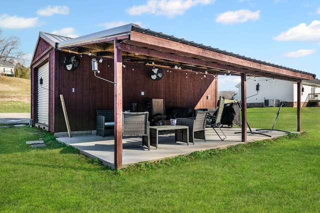 rear view of property with cooling unit, a patio area, an outdoor structure, and a lawn