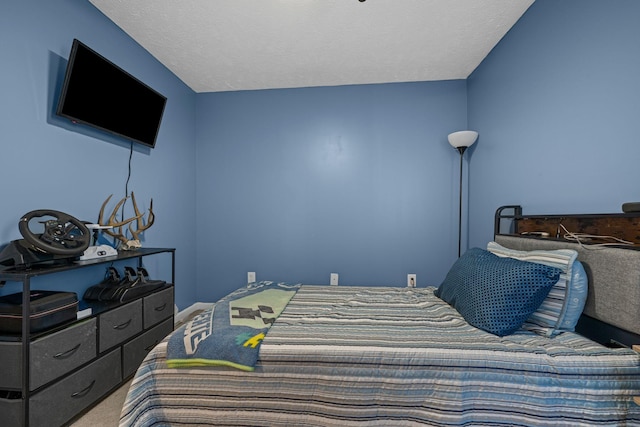 bedroom featuring a textured ceiling and carpet flooring