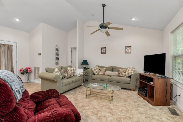 carpeted living room featuring ceiling fan and lofted ceiling