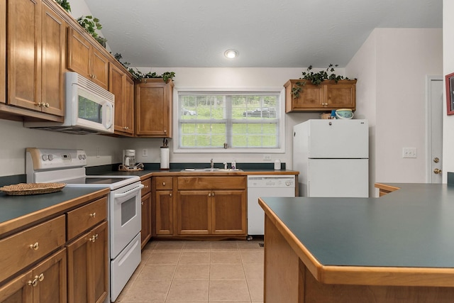 kitchen featuring sink, white appliances, and light tile patterned floors