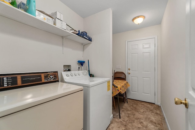 laundry room featuring washing machine and dryer and light carpet