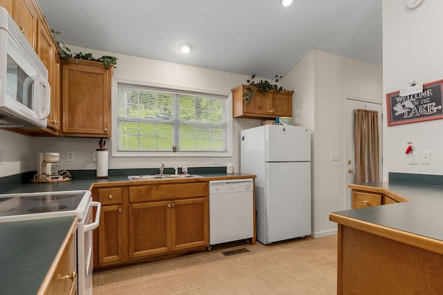 kitchen with light tile patterned floors, sink, and white appliances