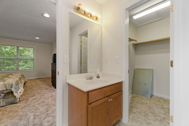 bathroom featuring a textured ceiling and vanity