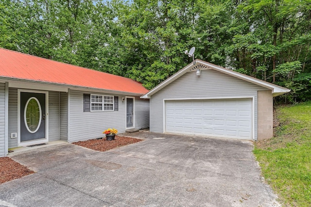 single story home with an outdoor structure and a garage