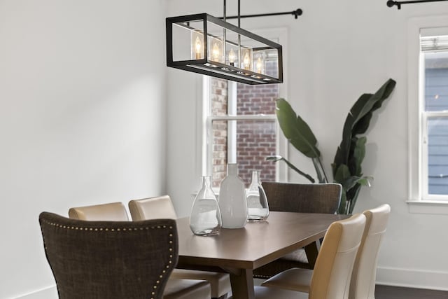 dining area with a wealth of natural light and an inviting chandelier