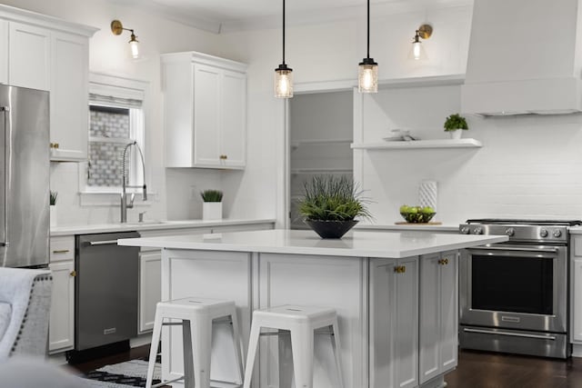 kitchen with a kitchen bar, white cabinetry, stainless steel appliances, and custom range hood