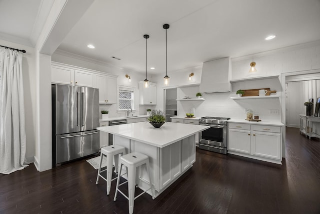 kitchen featuring decorative backsplash, white cabinets, custom range hood, and high quality appliances