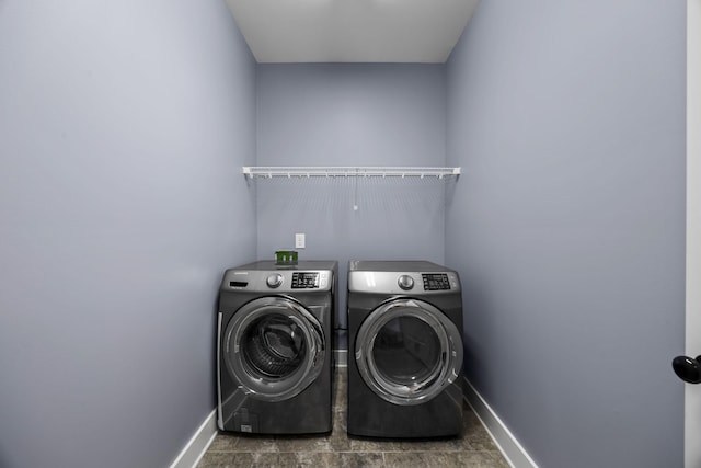 clothes washing area with separate washer and dryer