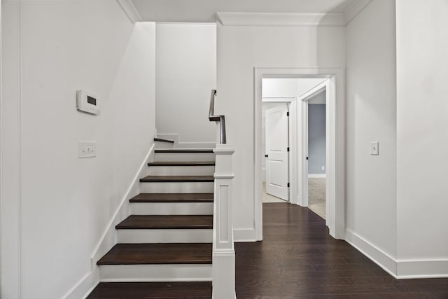 stairway featuring hardwood / wood-style floors and ornamental molding