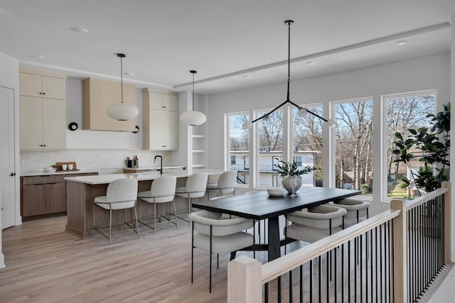 dining room featuring light hardwood / wood-style flooring and a healthy amount of sunlight