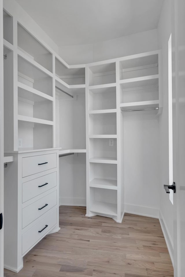 walk in closet featuring light hardwood / wood-style floors