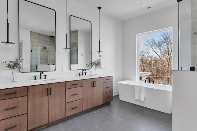 bathroom featuring plus walk in shower, tile patterned floors, and vanity