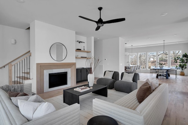 living room featuring ceiling fan and light hardwood / wood-style flooring