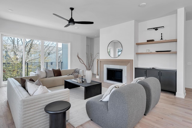 living room with ceiling fan and light hardwood / wood-style floors