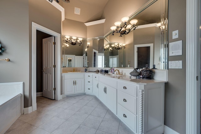 bathroom with tile patterned flooring, vanity, a tub, and a chandelier