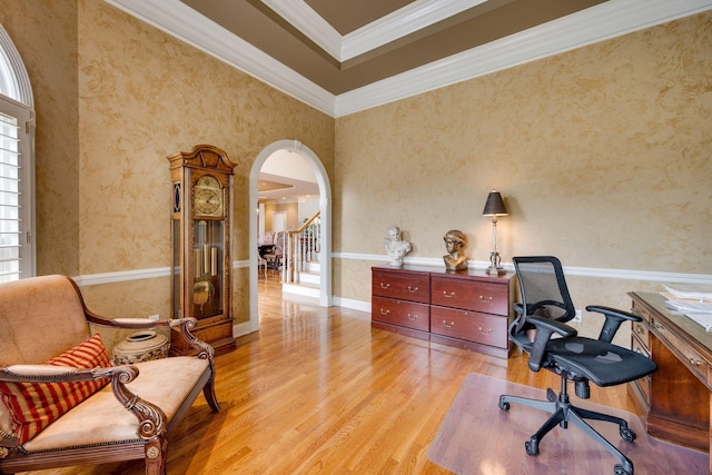 office space with crown molding and light wood-type flooring