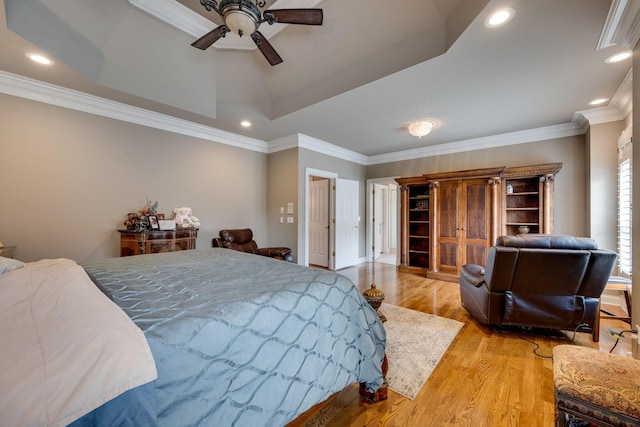 bedroom with ornamental molding, ceiling fan, and light wood-type flooring