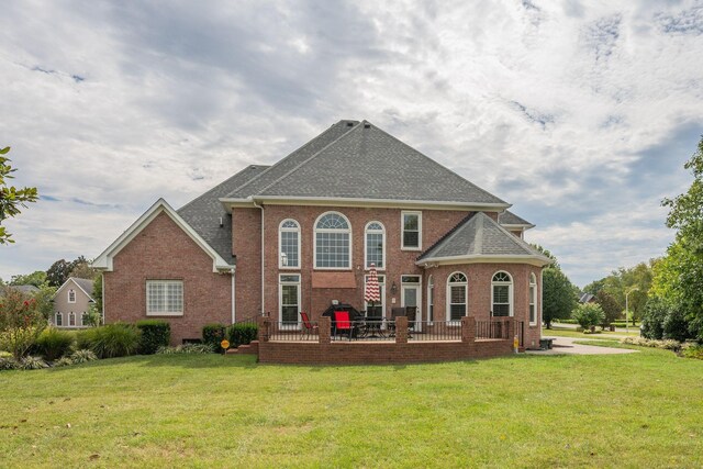 rear view of property with a yard and a patio