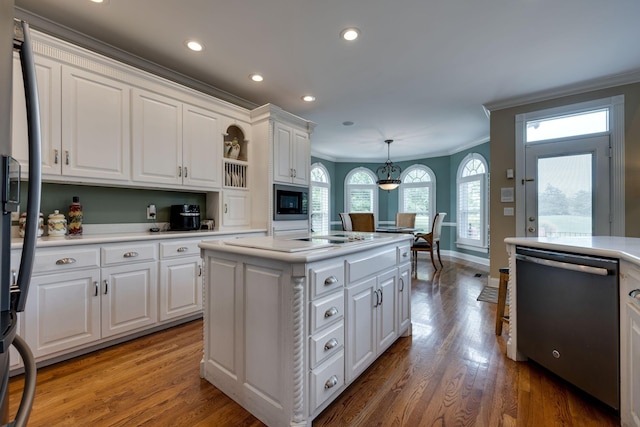 kitchen featuring white cabinetry, stainless steel appliances, a kitchen island, and hanging light fixtures