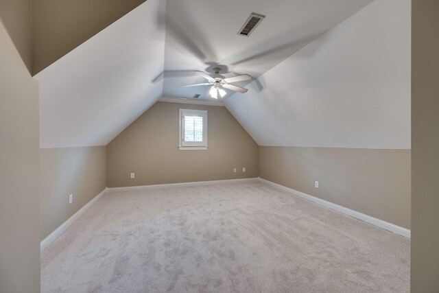 additional living space featuring lofted ceiling and light carpet