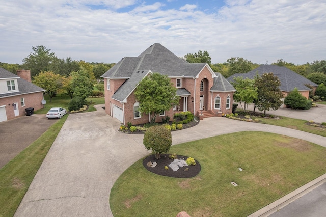 view of front of house featuring a front yard and a garage