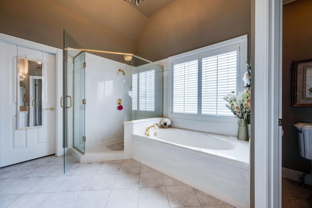 bathroom featuring tile patterned floors, shower with separate bathtub, and vaulted ceiling