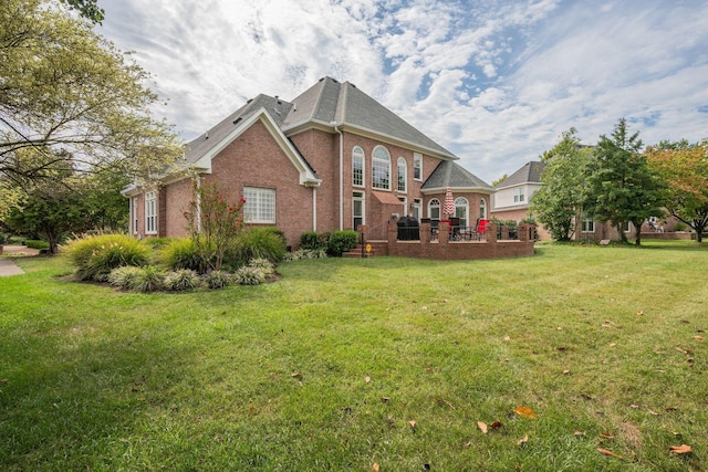 rear view of property featuring a yard