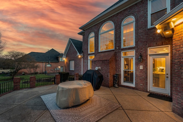 patio terrace at dusk with a grill