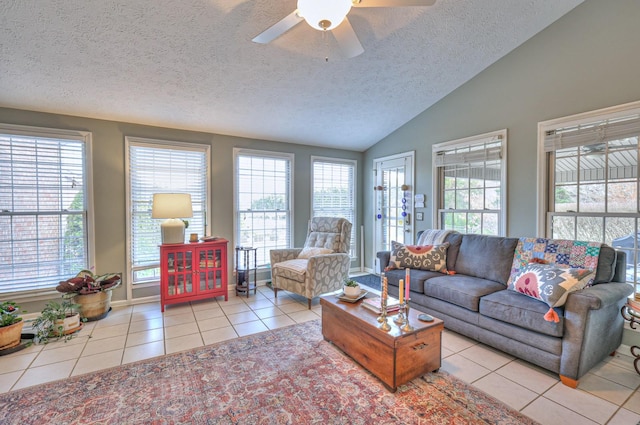 living room featuring vaulted ceiling, light tile patterned floors, a textured ceiling, and plenty of natural light