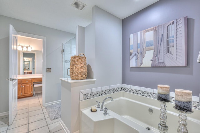 bathroom featuring plus walk in shower, vanity, and tile patterned flooring