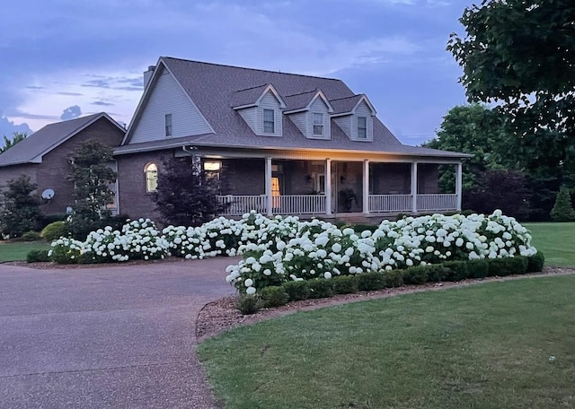 view of front facade with a yard and a porch