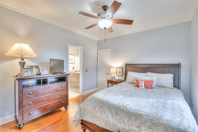 bedroom featuring light wood-type flooring, ceiling fan, crown molding, and ensuite bath