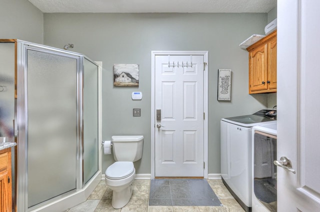 bathroom with a shower with shower door, washer and clothes dryer, vanity, and toilet