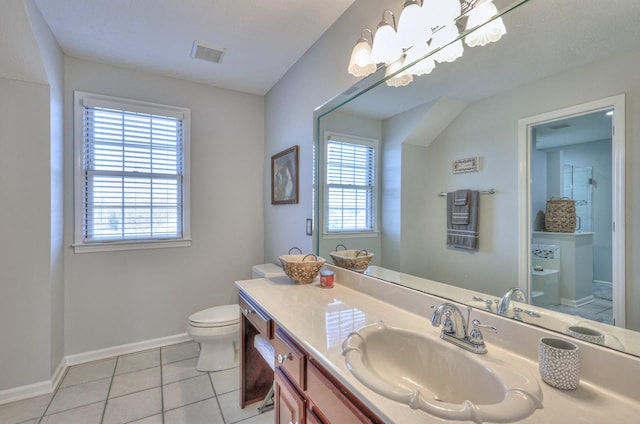 bathroom featuring a wealth of natural light, toilet, vanity, and tile patterned flooring