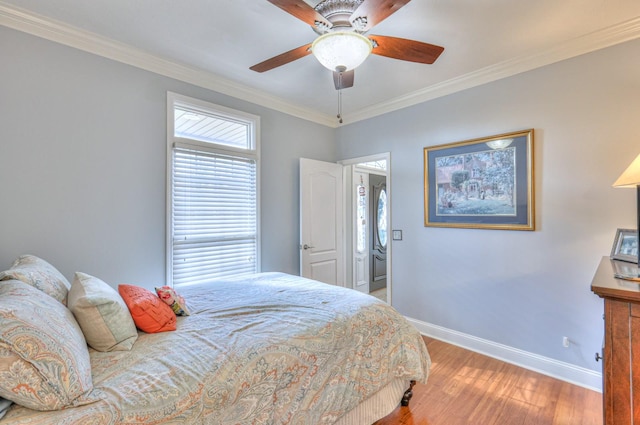 bedroom with ceiling fan, crown molding, and hardwood / wood-style flooring