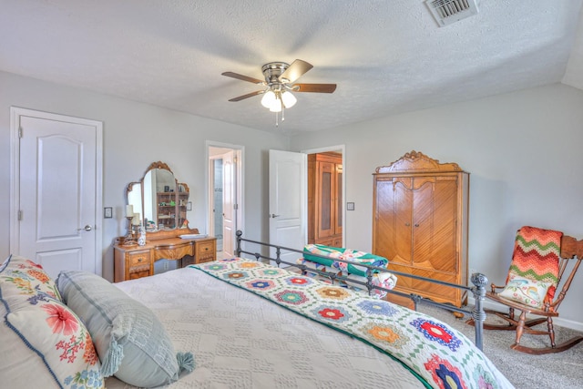 bedroom featuring a textured ceiling, ceiling fan, and carpet flooring