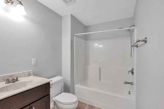 full bathroom featuring wood-type flooring, toilet, vanity, and  shower combination