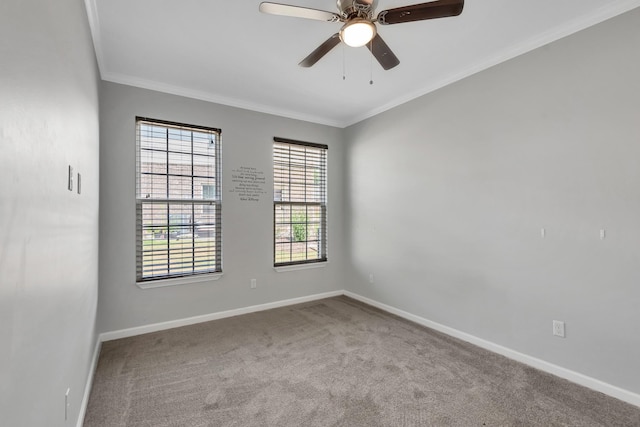 carpeted spare room featuring ceiling fan and crown molding