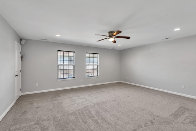 carpeted empty room featuring ceiling fan