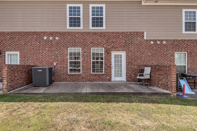 rear view of property featuring central AC, a yard, and a patio