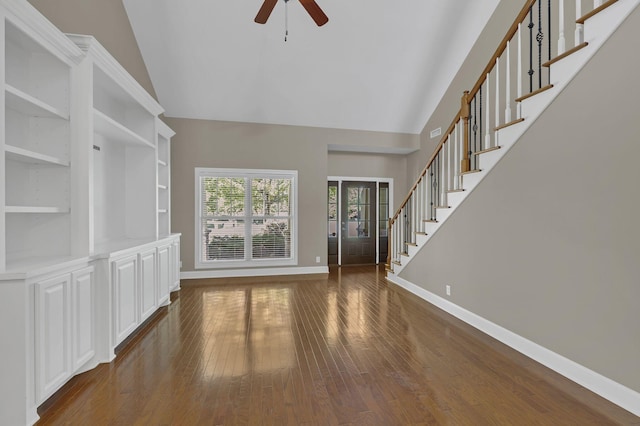 unfurnished living room with dark wood-type flooring, french doors, built in features, vaulted ceiling, and ceiling fan